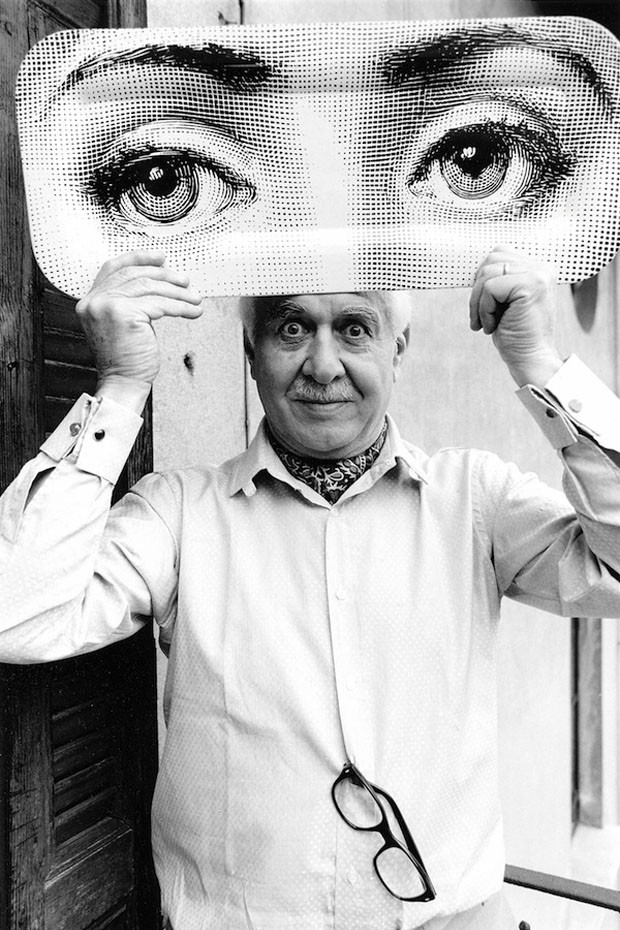 Piero Fornasetti holding a Tray with Lina's eyes Image Courtesy of Fornasetti.