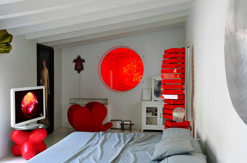 Fabio Novembre home studio in Milan. A large circular window offers views between Fabio and Candela’s room, and their daughters’ Image © Molteni & Motta, Courtesy of Home Portraits.